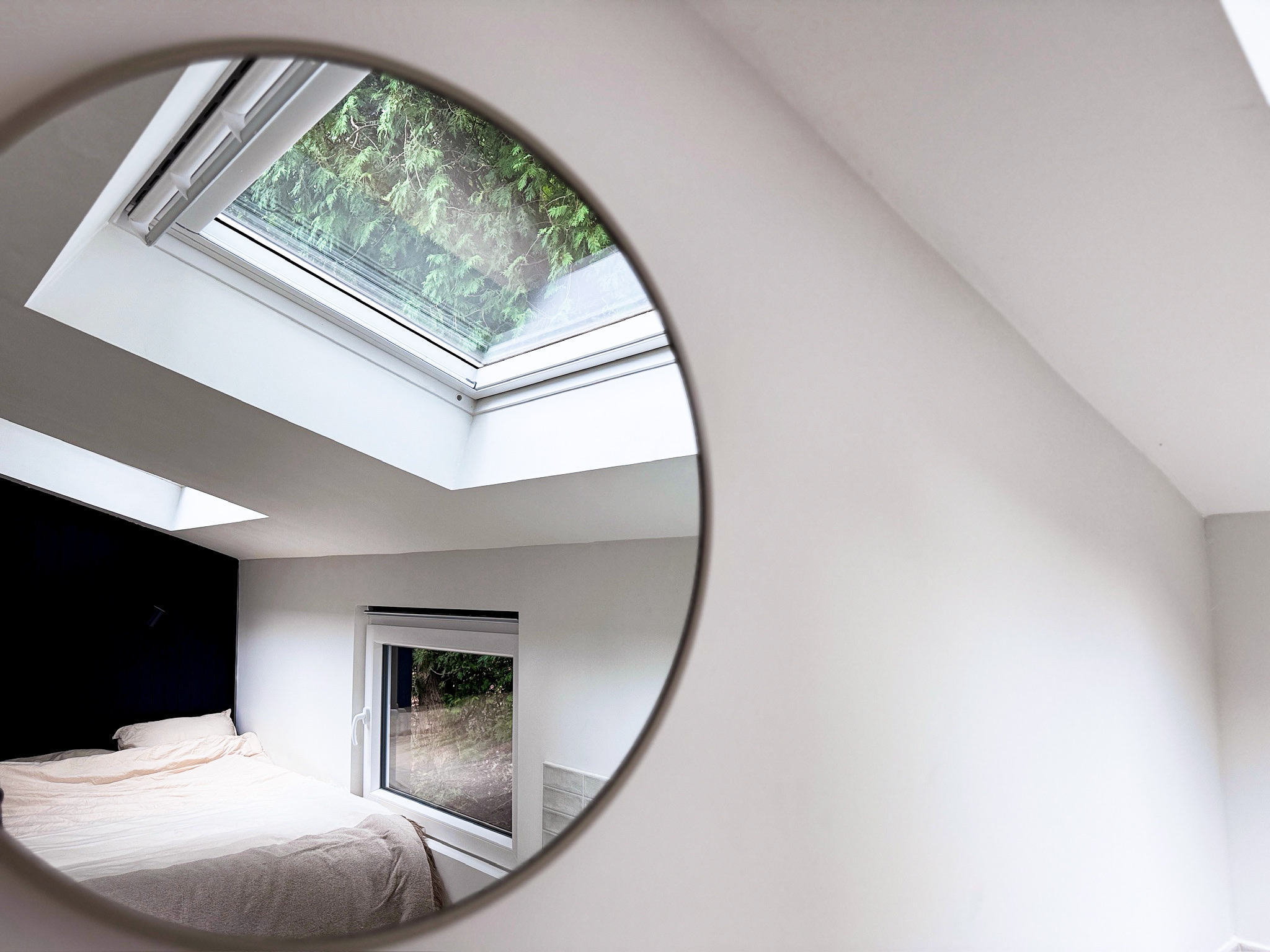 Bedroom mirror reflecting skylight